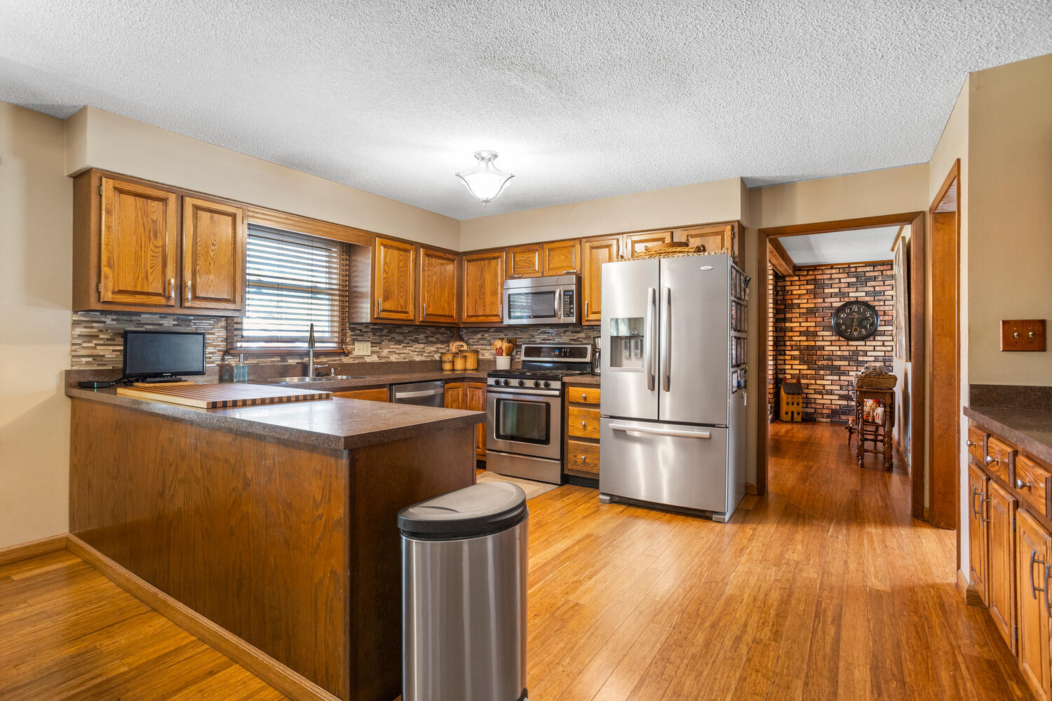 1437 Golf Terrace Danville, IL 61832 - Photo 12 of 40 a kitchen with stainless steel appliances granite countertop a refrigerator stove top oven and sink