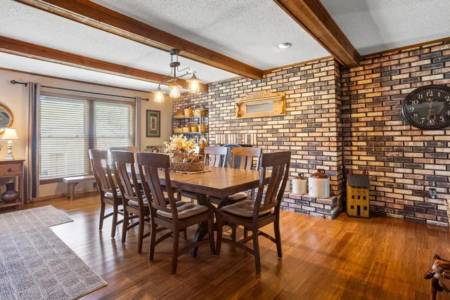 a view of a dining room with furniture and chandelier