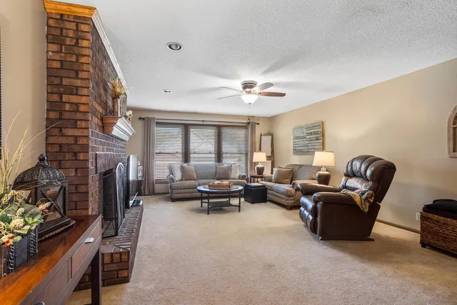 a living room with furniture a clock and a window