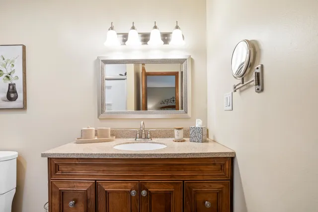 a bathroom with a toilet sink and shower
