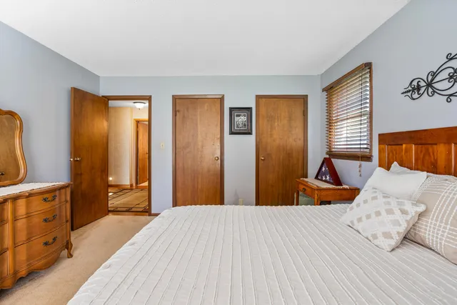 a view of a hallway with a wall clock and a wall painting