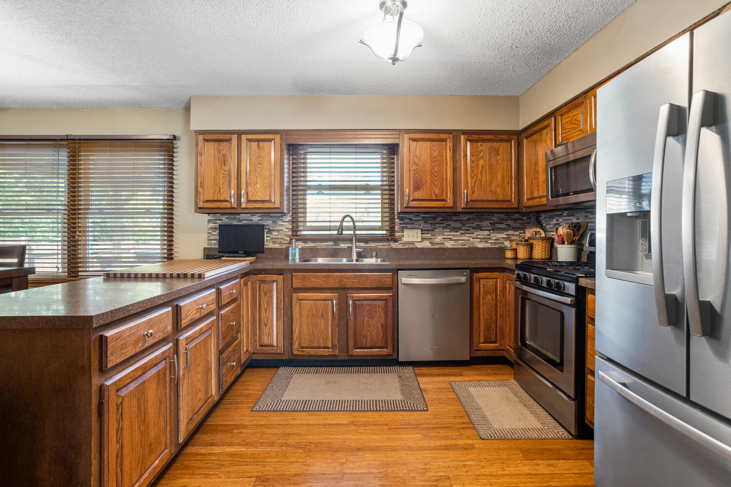 1437 Golf Terrace Danville, IL 61832 - Photo 8 of 40 a kitchen with stainless steel appliances granite countertop a stove a sink and a refrigerator