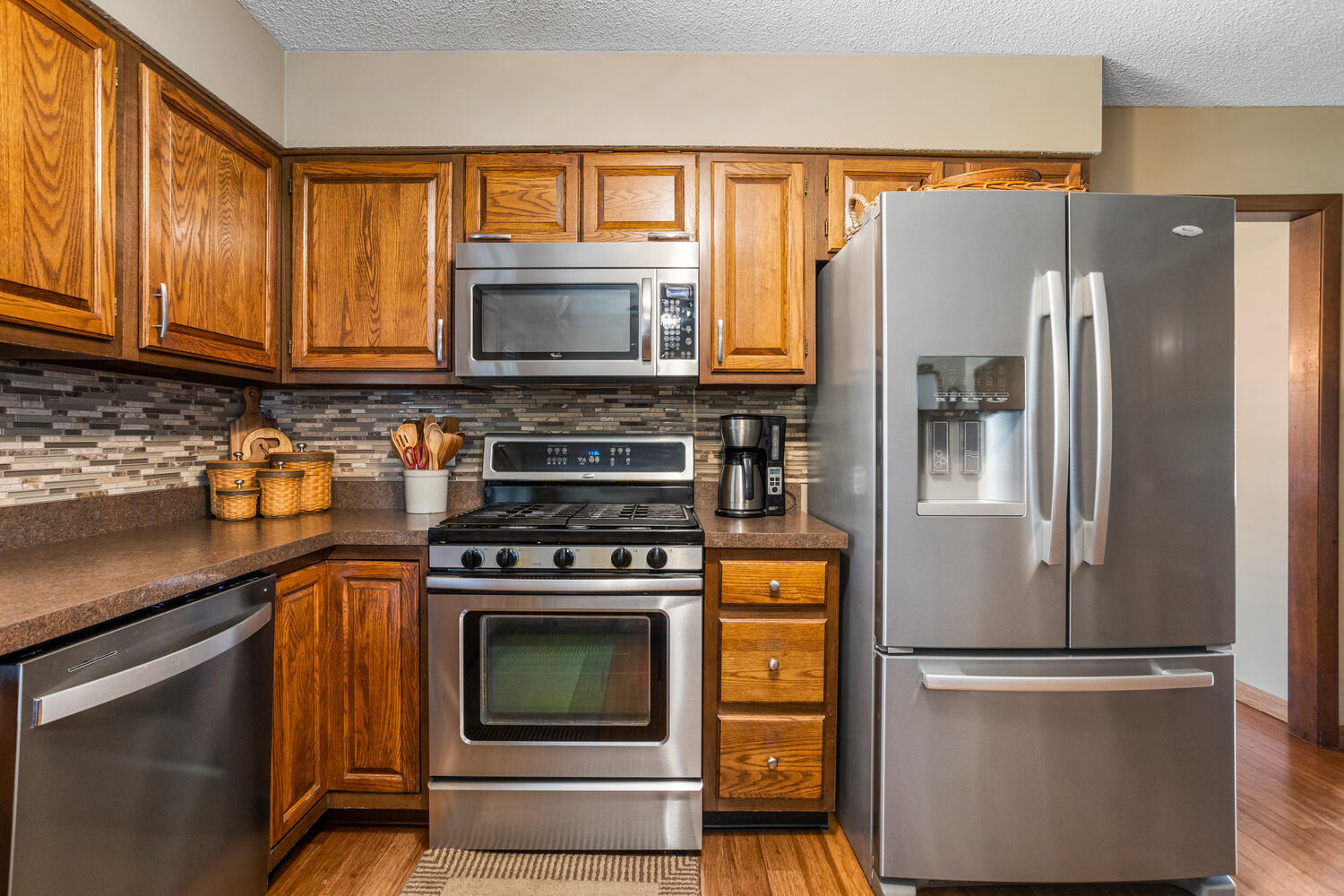 1437 Golf Terrace Danville, IL 61832 - Photo 10 of 40 a kitchen with stainless steel appliances granite countertop a refrigerator stove and sink