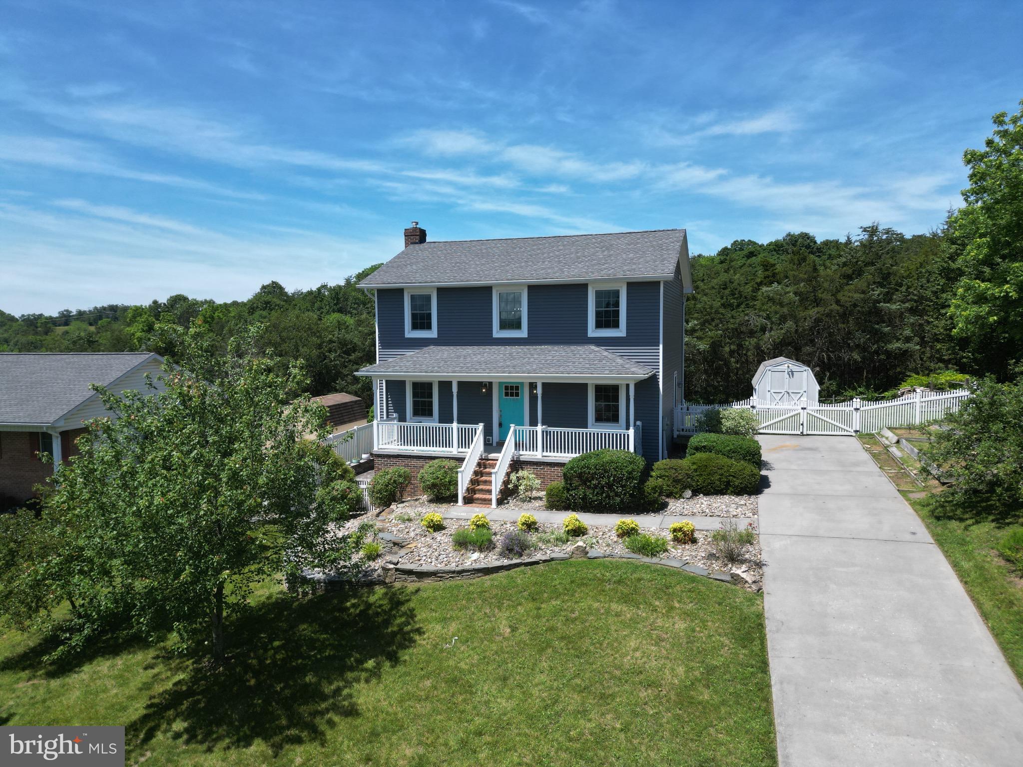 1185 Kesler Road Front Royal, VA 22630 - Photo 6 of 51 a front view of a house with a yard table and chairs