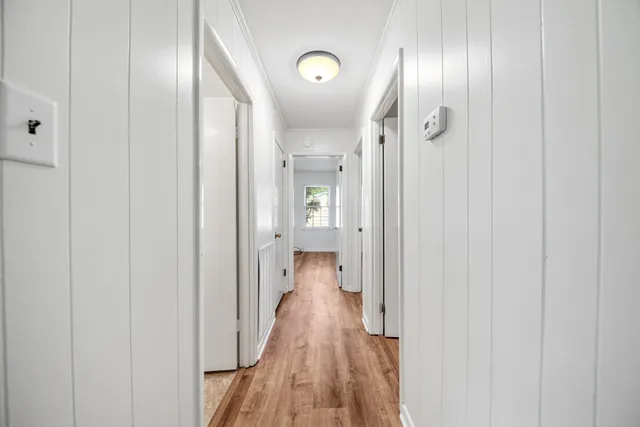 a view of a hallway with wooden floor