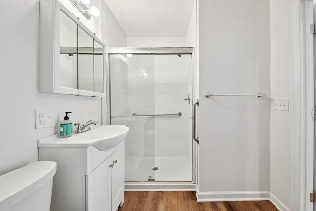 a bathroom with a sink a toilet and shower