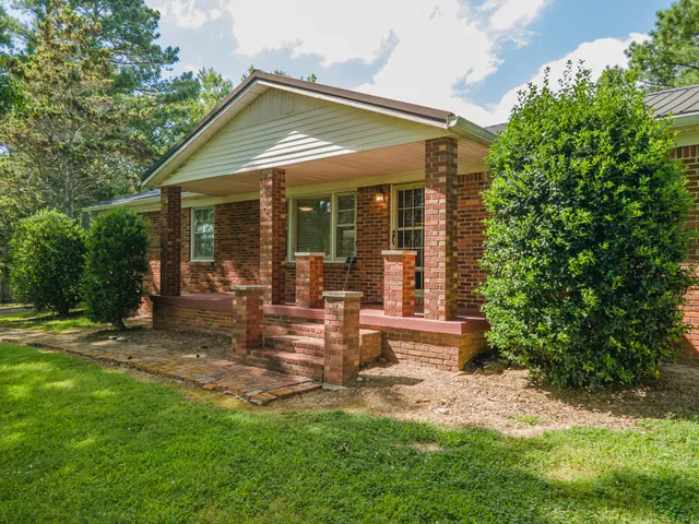 a view of a house with backyard porch and sitting area