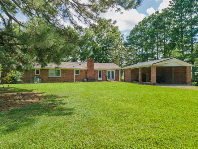 a front view of house with yard and green space
