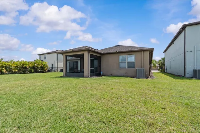 a view of house with backyard and garden