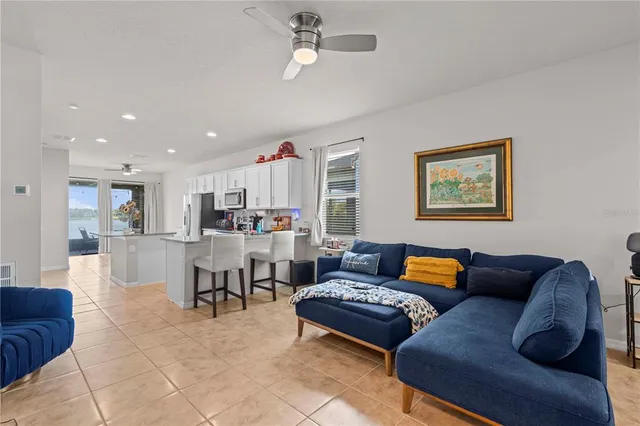 a living room with furniture kitchen view and a dining table