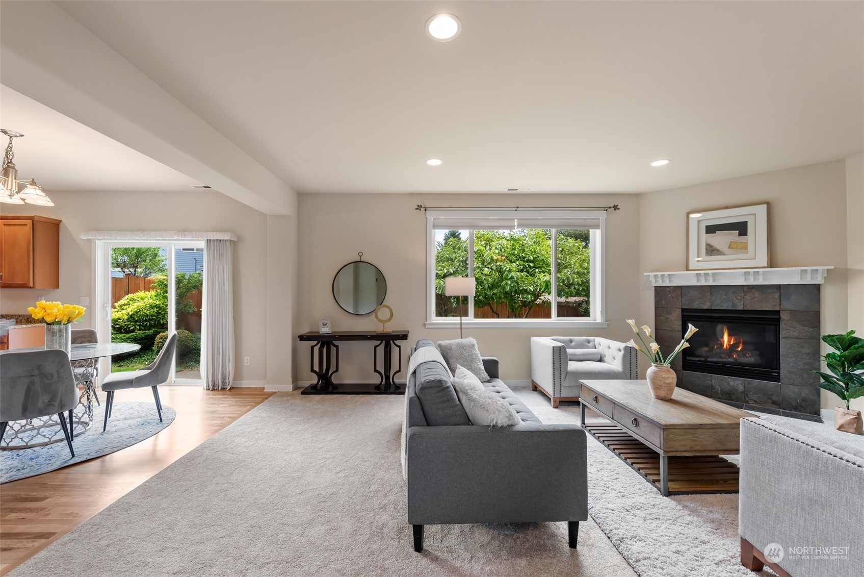 4022 220th Street Southeast Bothell, WA 98021 - Photo 5 of 24 a living room with furniture a fireplace and a large window