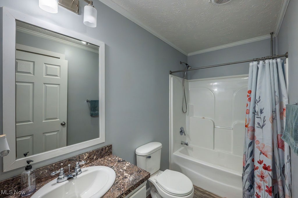 560 Wine Road Elizabeth, WV 26143 - Photo 13 of 50 Bathroom with shower / bathtub combination with curtain, ornamental molding, vanity, and a textured ceiling