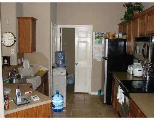 a kitchen with stainless steel appliances granite countertop a refrigerator and a stove