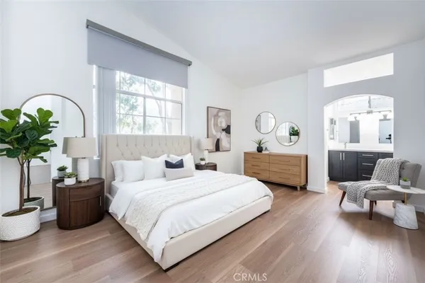 a bedroom with a bed window and potted plant
