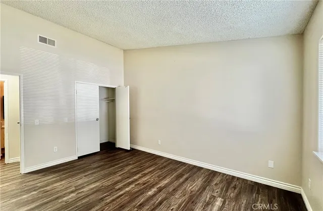 a view of an empty room and wooden floor