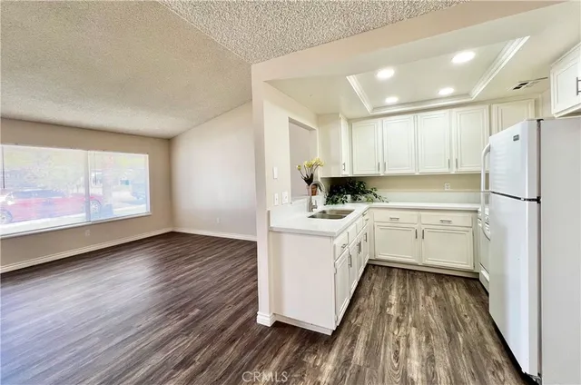 a kitchen with white cabinets and white appliances