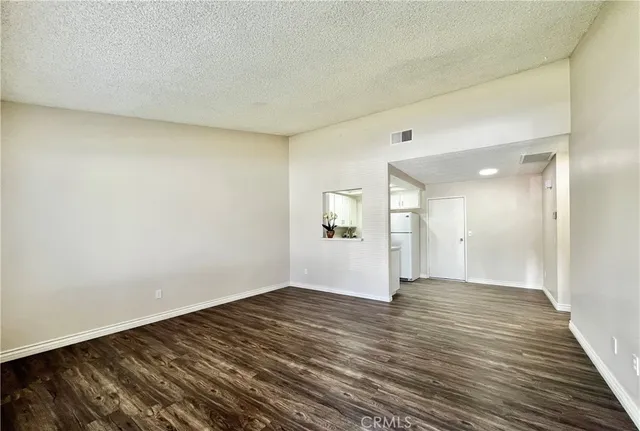 a view of an empty room and wooden floor