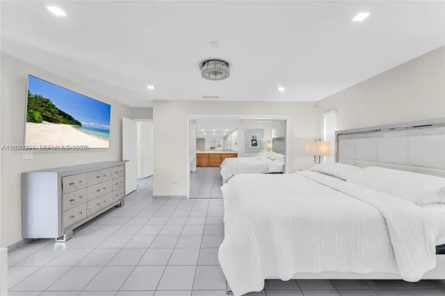 a bedroom with a bed and a night stand