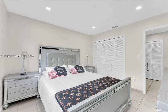 a bedroom with a bed and a night stand