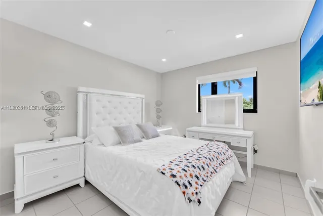 a bedroom with a large bed and a walk in closet