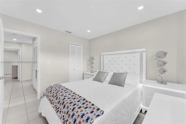 a spacious bedroom with a bed and a walk in closet