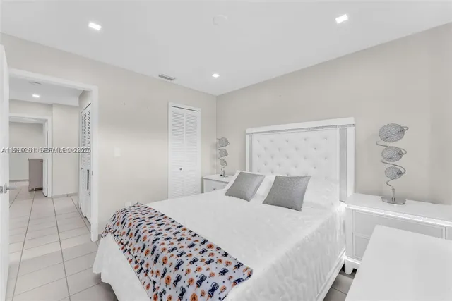 a spacious bedroom with a bed and a walk in closet