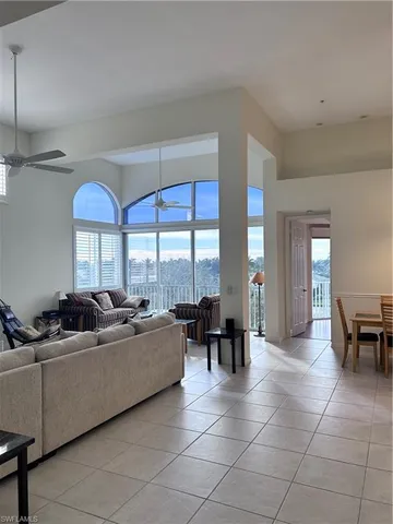 a living room with furniture and large windows