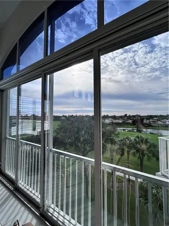a view of a balcony next to a yard