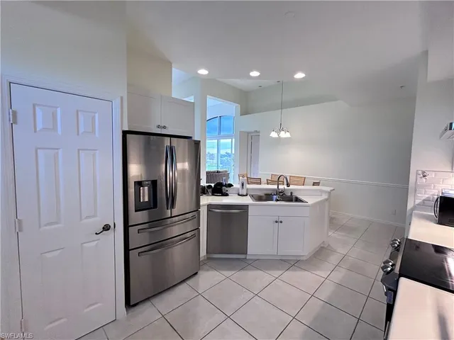 a kitchen with a sink stainless steel appliances and cabinets
