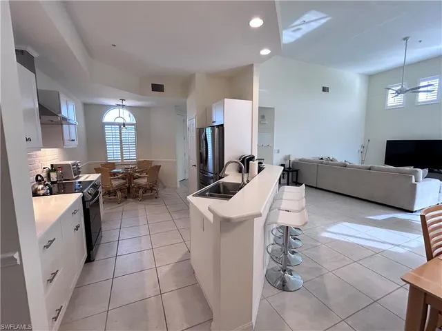 a large white kitchen with cabinets