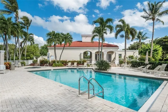 a view of a house with swimming pool and sitting area