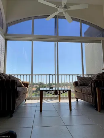 a balcony with furniture and a ceiling fan