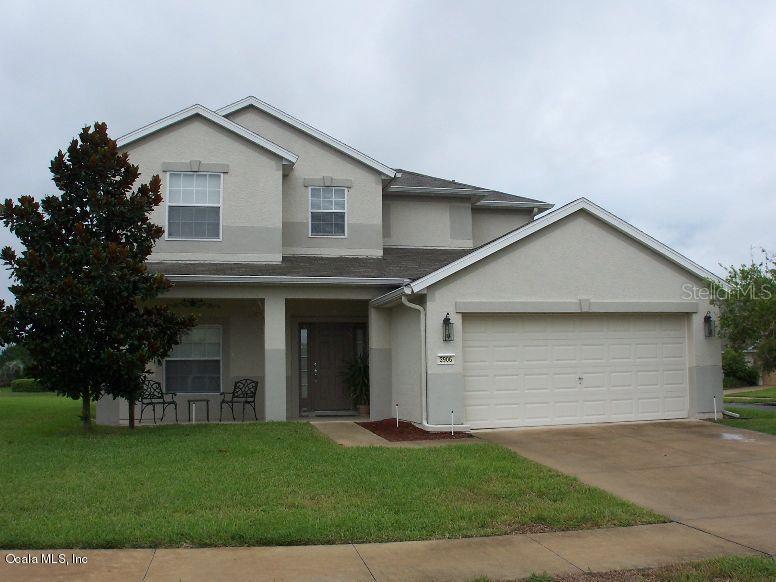3906 Southwest 51st Terrace Ocala, FL 34474 - Photo 1 of 1 a view of a white house next to yard and large trees