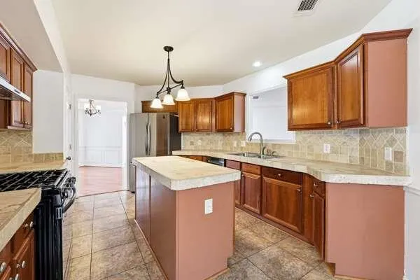 a kitchen that has a lot of cabinets in it