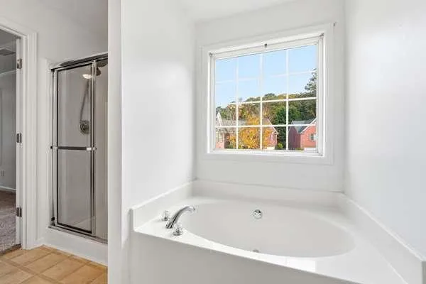 a white bath tub sitting next to a window