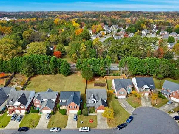 an aerial view of residential houses with outdoor space