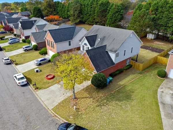 an aerial view of a house with swimming pool and big yard
