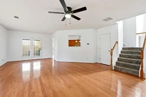wooden floor in an empty room with a window
