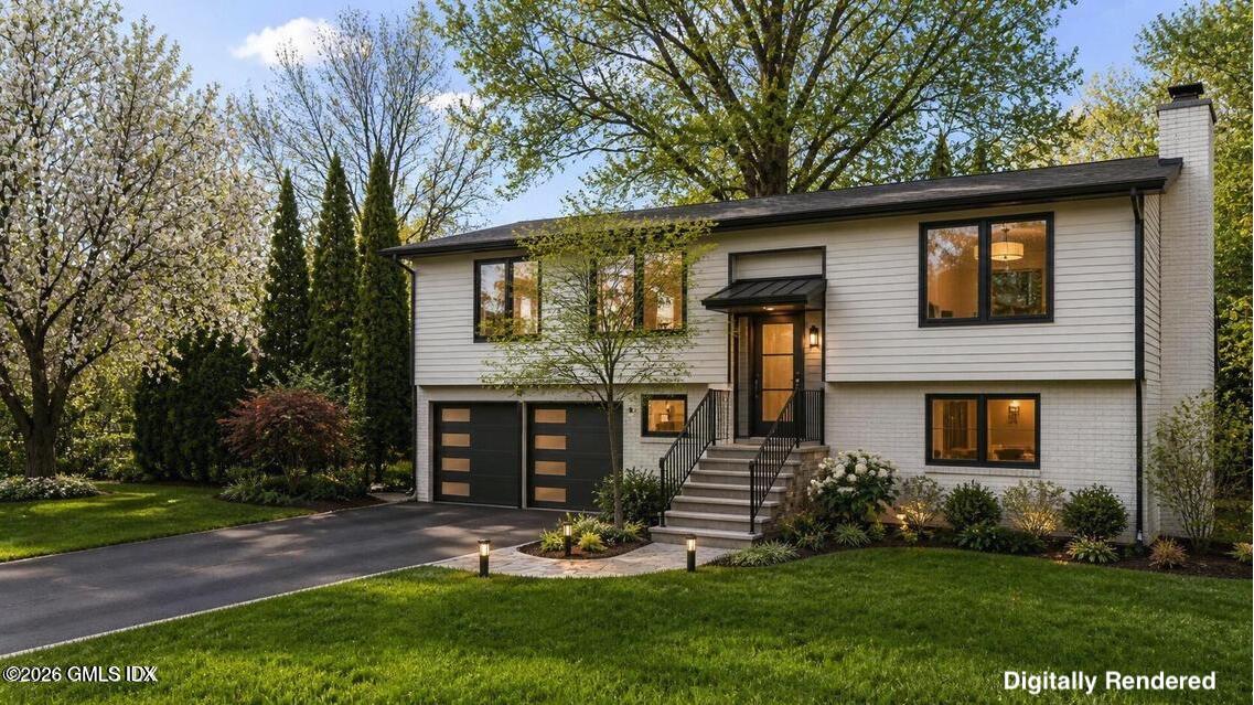 22 Carrona Drive Riverside, CT 06878 - Photo 2 of 26 a front view of a house with a yard and trees