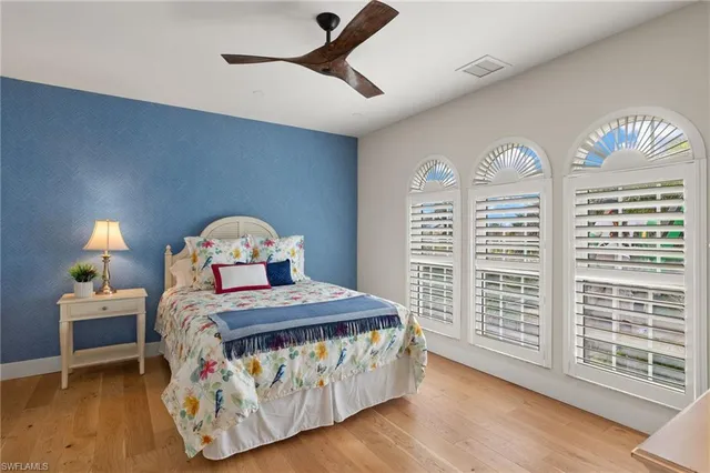 a bedroom with a bed a window and dresser