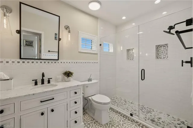 a bathroom with a toilet sink and shower