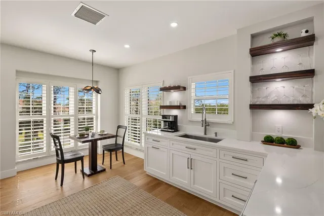 a kitchen with stainless steel appliances kitchen island granite countertop a stove a sink and a refrigerator