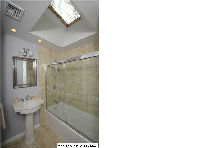 14 Highpoint Road Holmdel, NJ 07733 - Photo 14 of 17 a bathroom with a shower a mirror and a sink