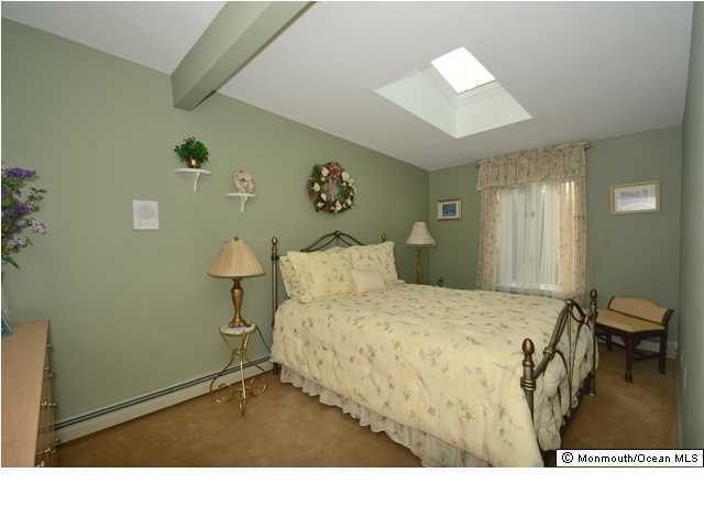 14 Highpoint Road Holmdel, NJ 07733 - Photo 15 of 17 a room with a bed and a painting on the wall