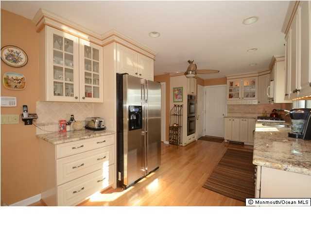14 Highpoint Road Holmdel, NJ 07733 - Photo 4 of 17 a kitchen with stainless steel appliances kitchen island granite countertop a refrigerator and cabinets