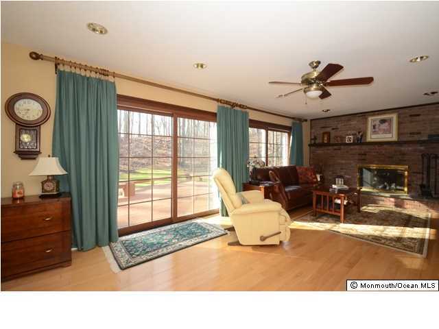 14 Highpoint Road Holmdel, NJ 07733 - Photo 9 of 17 a living room with furniture a window and a fireplace