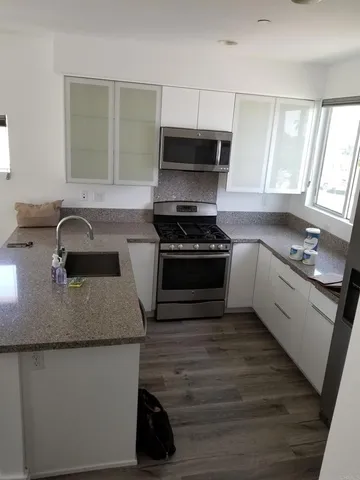 a kitchen with a sink stove and microwave
