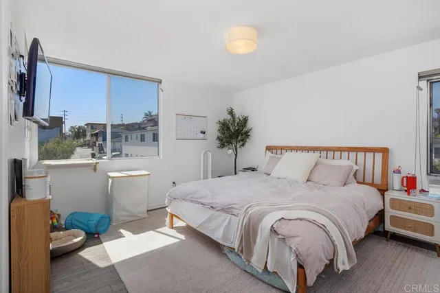 a bedroom with a large bed and a window