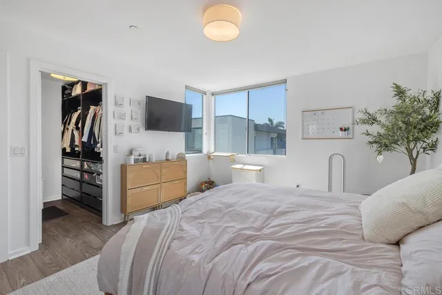 a bedroom with a bed and a flat screen tv