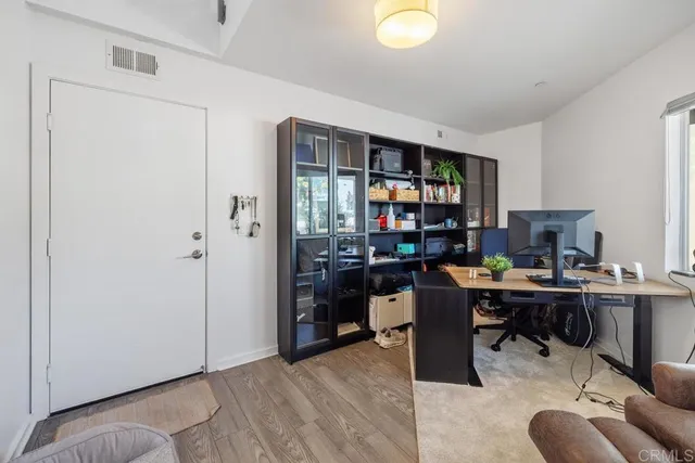 a view of a workspace with furniture and a window